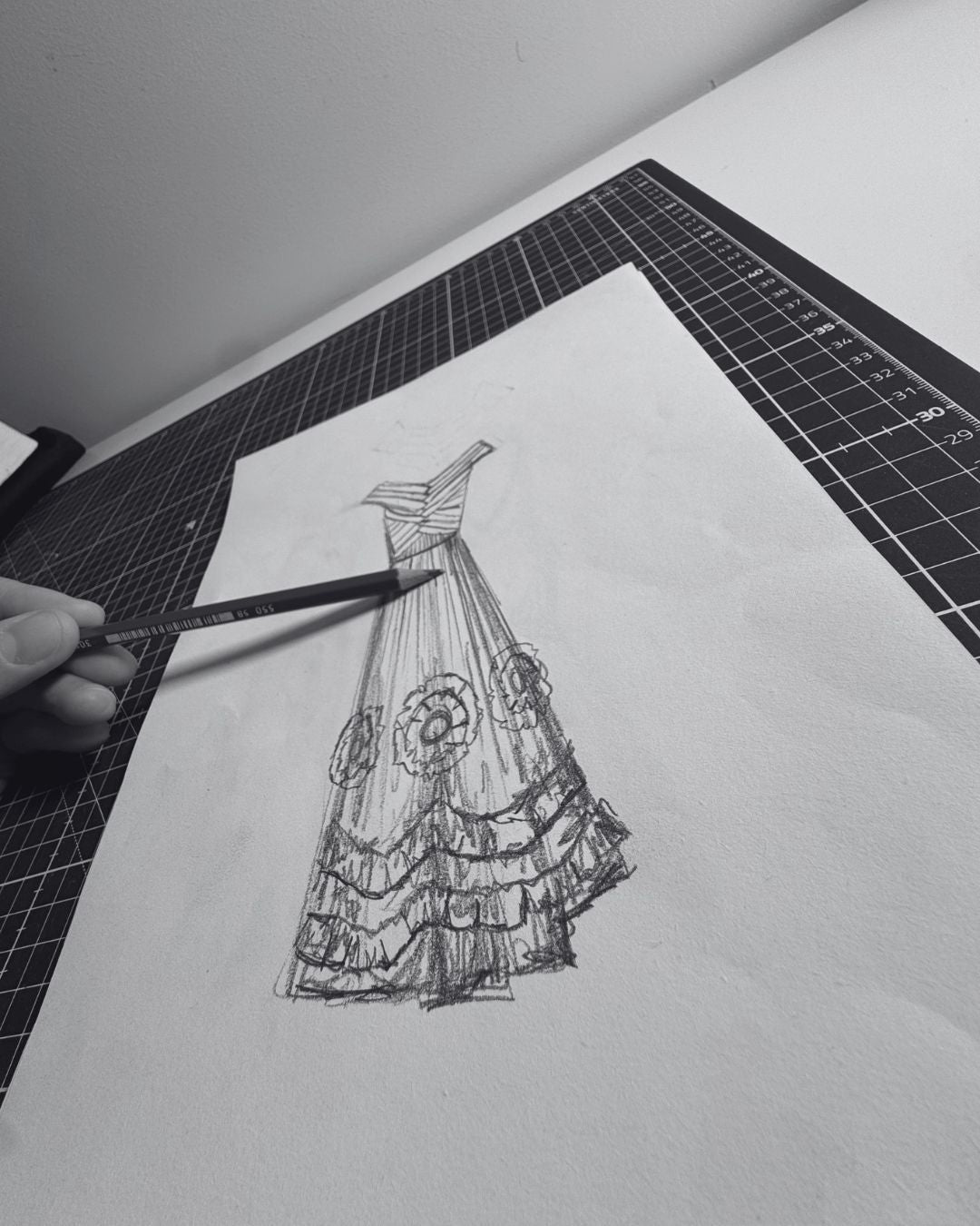 Sketch on paper of a bohemian dress with a pencil