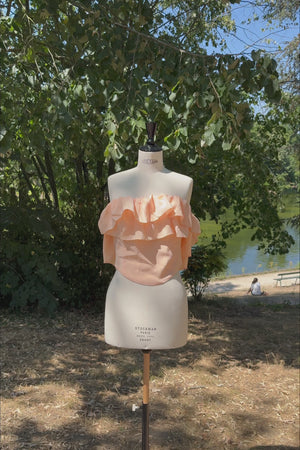 VKELLER Ruth peach off-shoulder ruffle silk top, shown outdoors.
