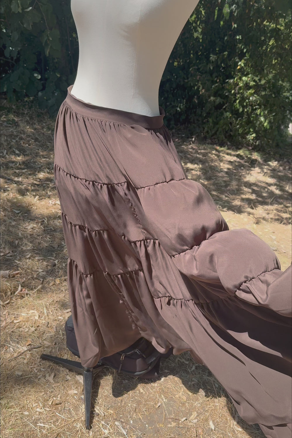 VKELLER Samara Chocolate tiered silk maxi skirt, shown outdoors.